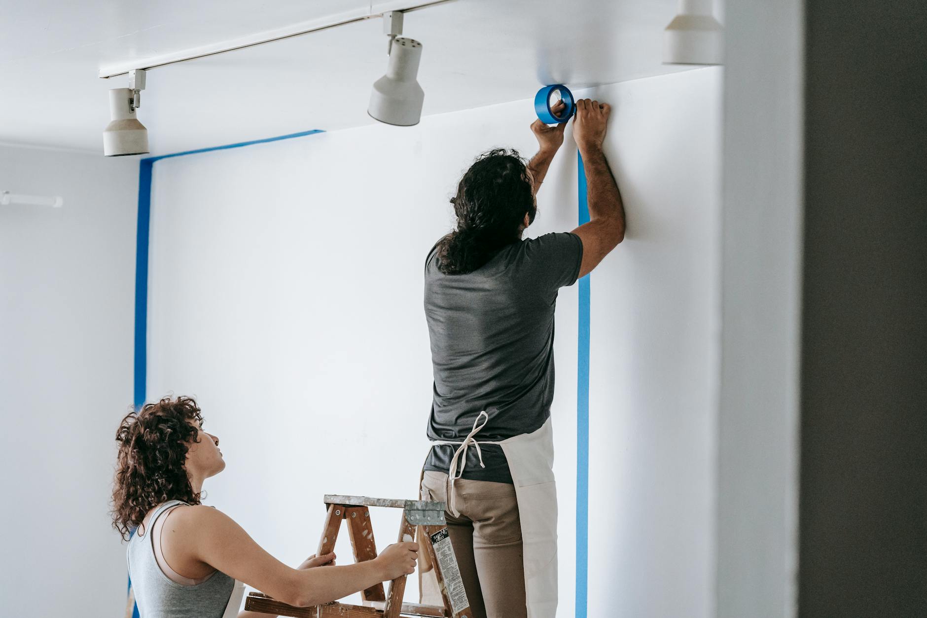 professional painter working on wall preparation