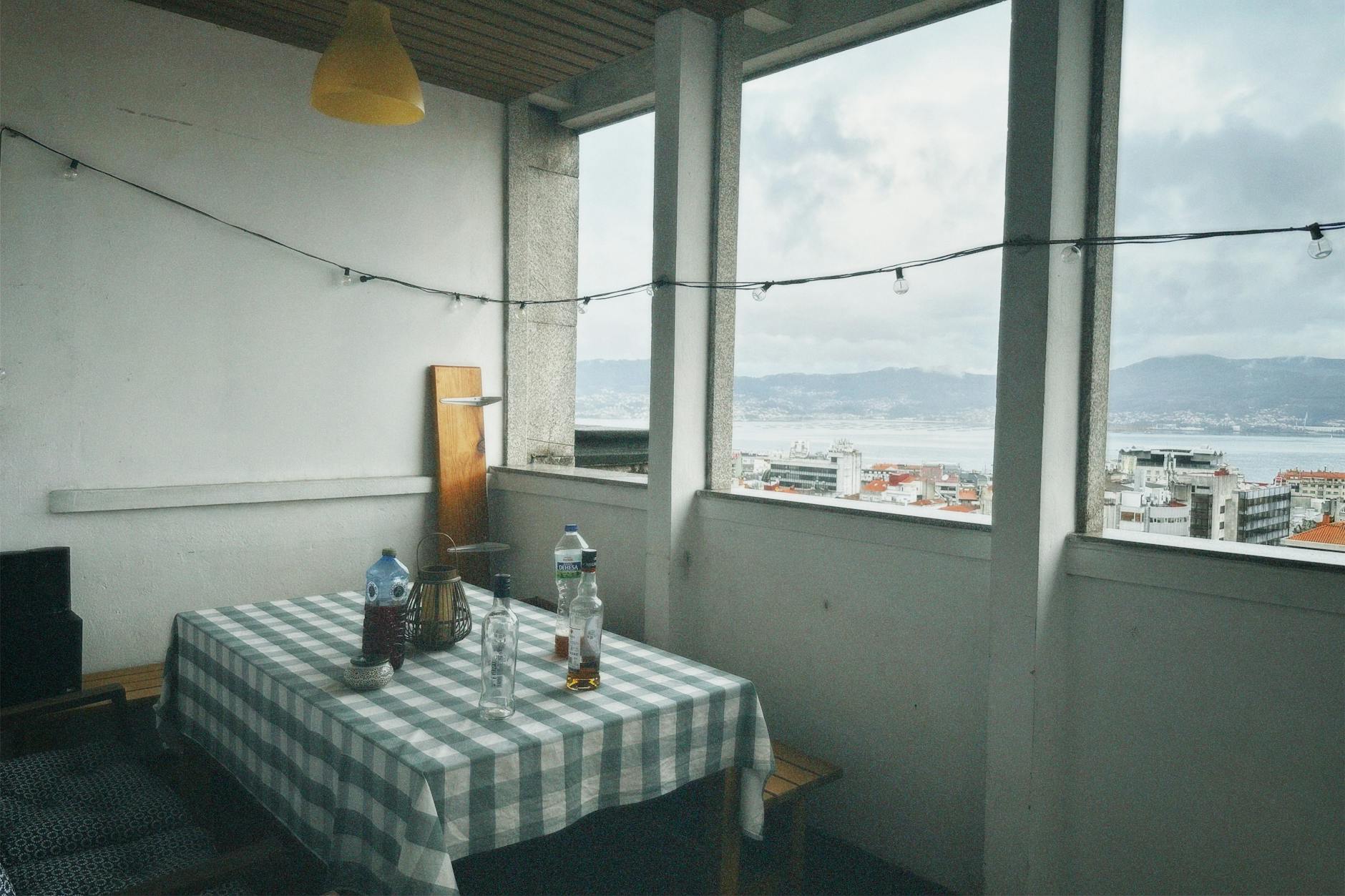 small balcony decor with cozy seating and string lights