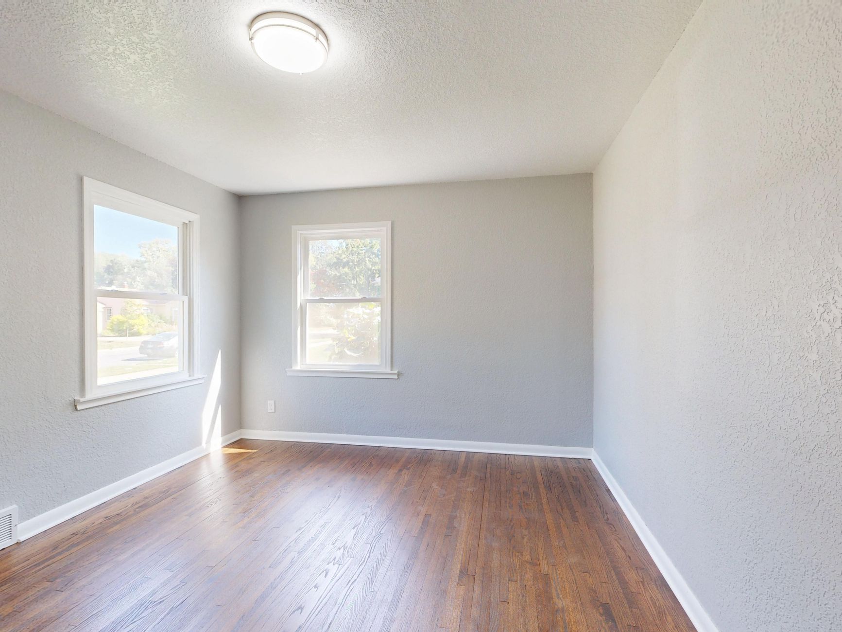 bright living room white walls large window