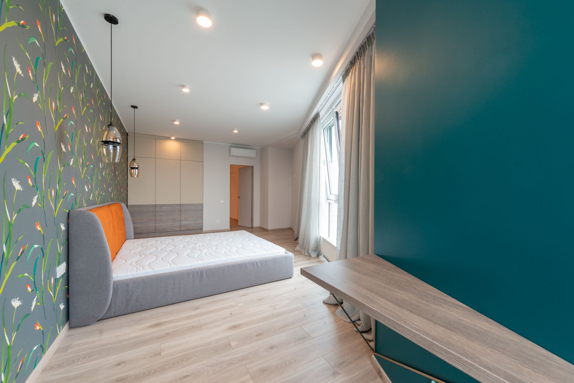cottagecore bedroom with floral wallpaper and wooden bed